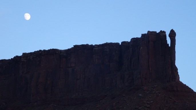 As the sun sets, the moon rises, and the river seems to stop.