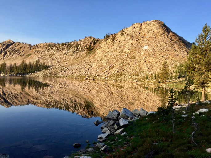 Lake Ingeborg reflects the montain side in the early morkning.