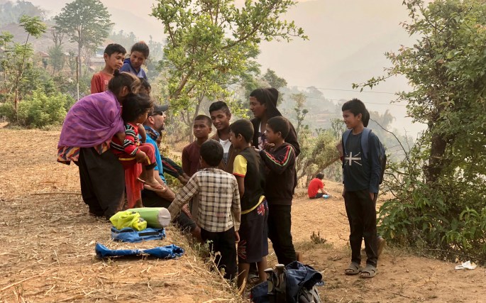 Kyle talks to the children.  But how?  Surely few know any English.