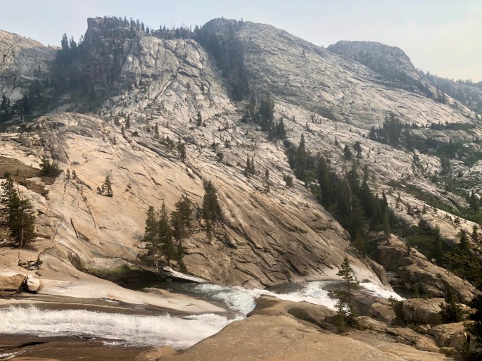 The Tuolumne River cascades down the canyon, which is not yet very deep.
