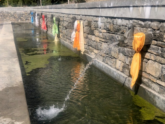 Sacred waterspouts behind Buddha