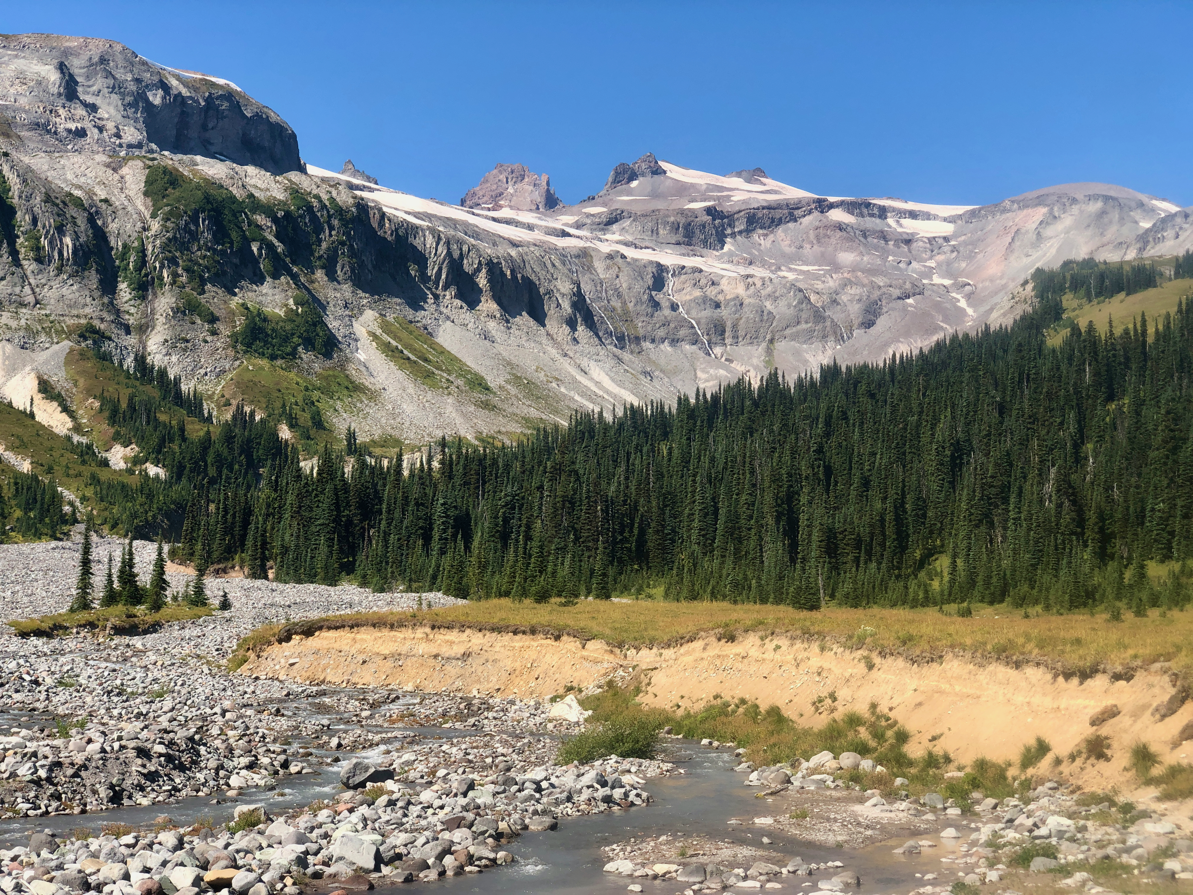 Waterfalls descend from a glacier to form a glacial river