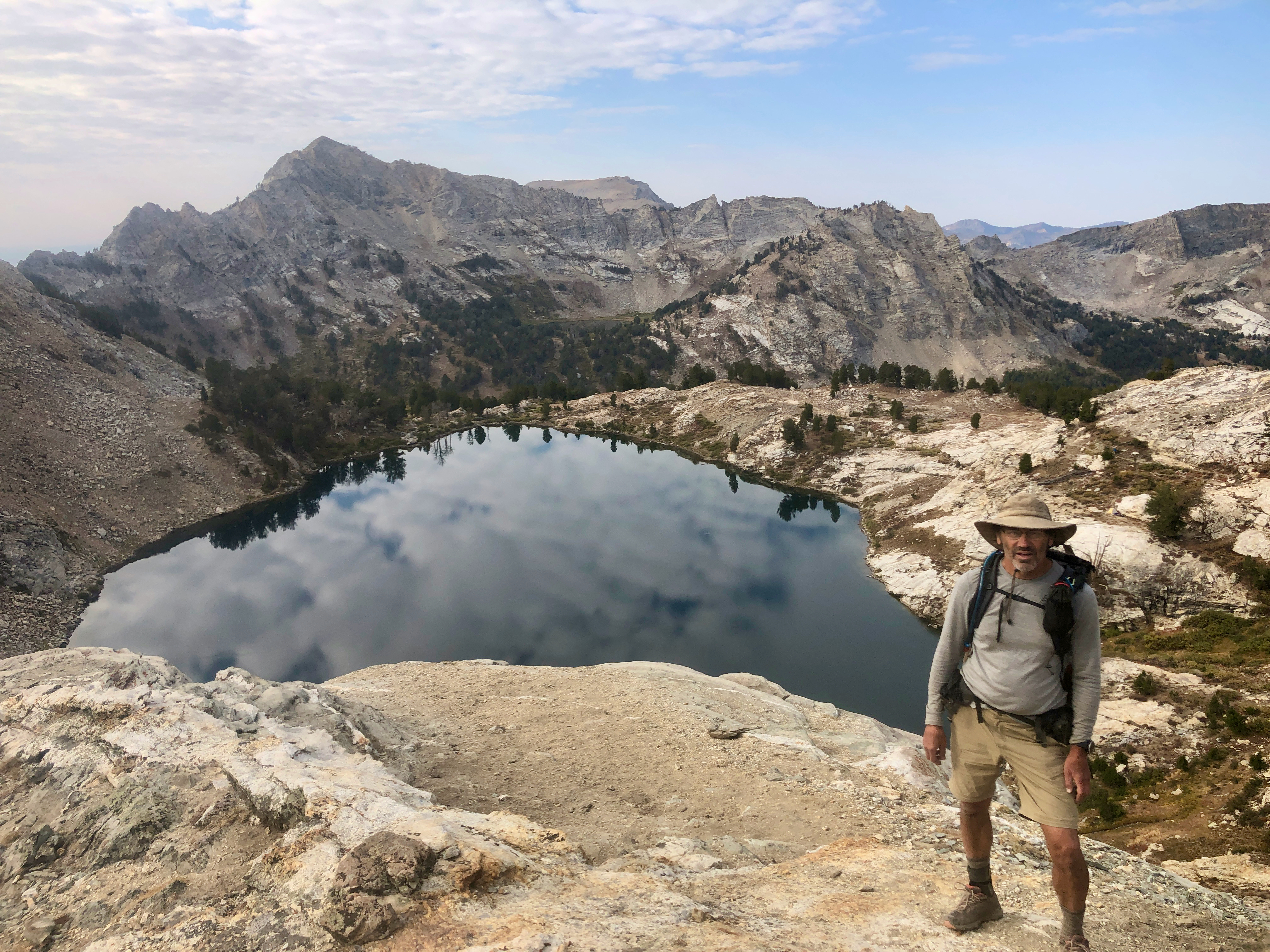 A hiker pauses on his morning hike above Liberty Lake