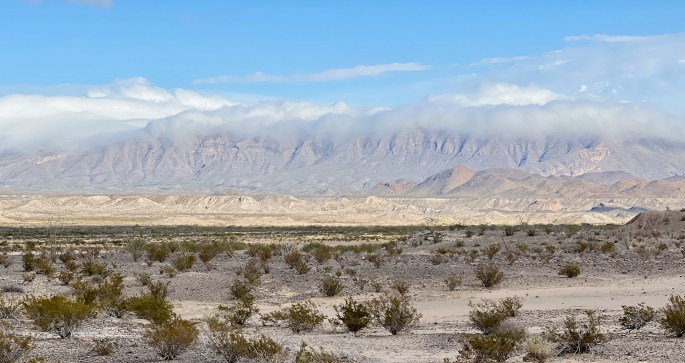 Interesting interplay between clouds, mountains and sun in the desert
